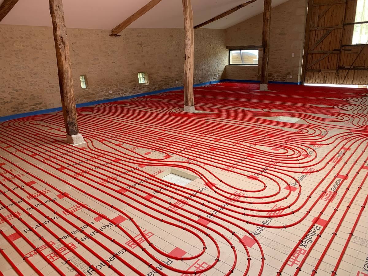 Plancher chauffant en cours de pose dans une grange rénovée